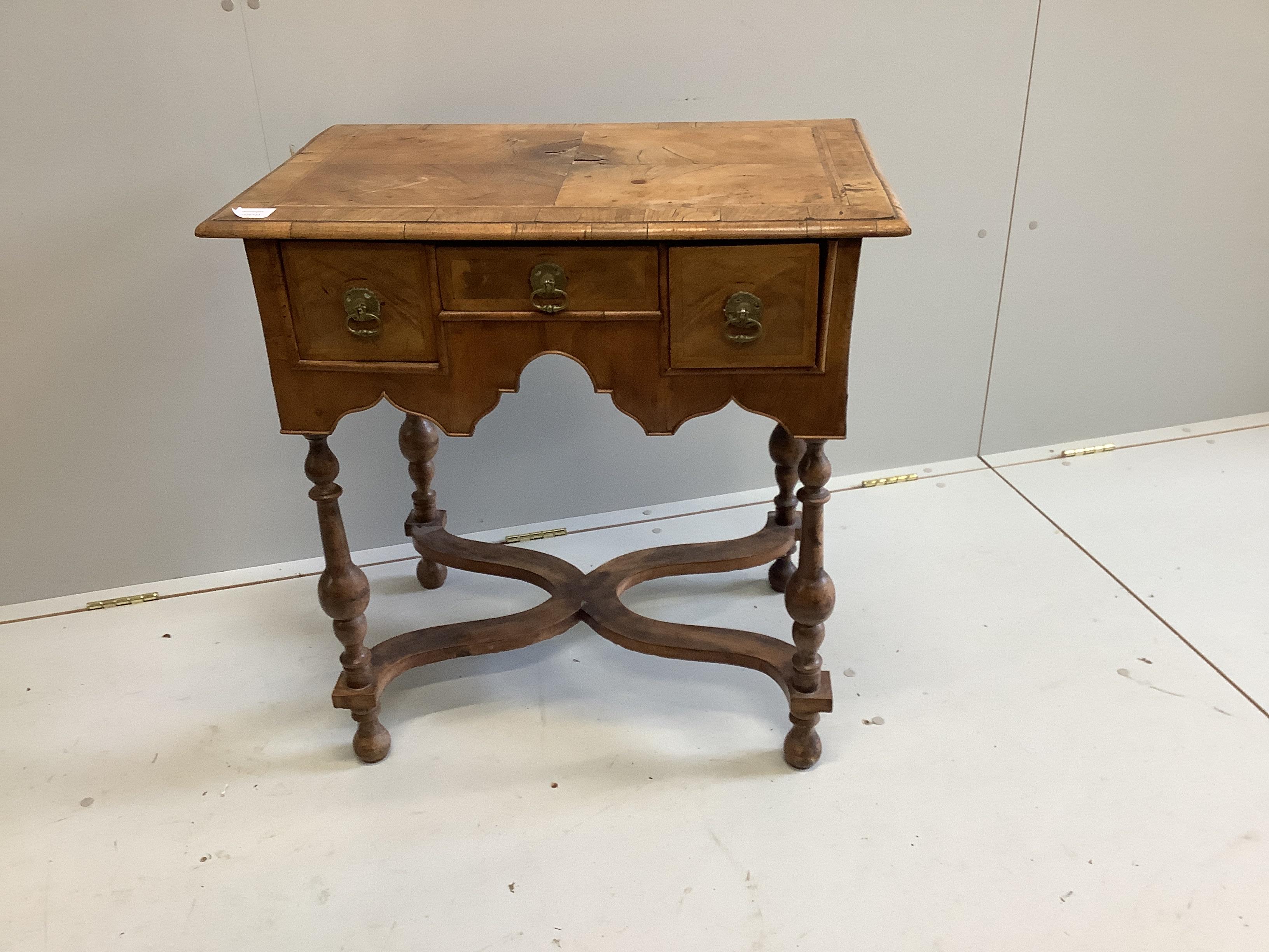 A small 18th century style feather banded walnut lowboy, width 73cm, depth 49cm, height 74cm